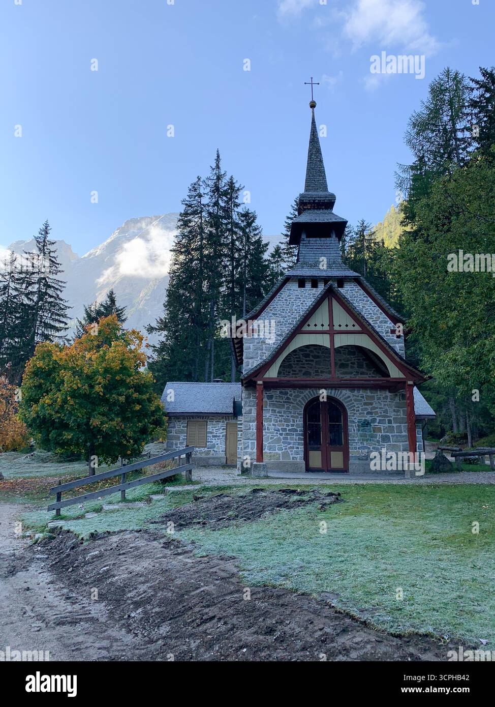 Lake Braies, Italy. View of the Chapel during autumn season. The Braies Lake and the small church near it. The Pragser Wildsee, or Lake Prags. - Smartphone Captured Stock Image