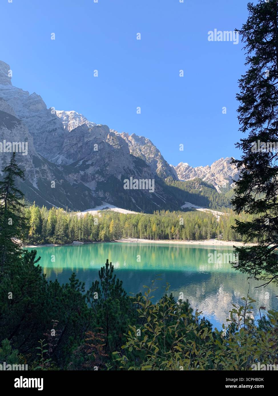 The Pragser Wildsee, or Lake Prags or Lake Braies in Dolomites in autumn, South Tyrol, Italy. The concept of walking and eco-tourism. - Smartphone Captured Stock Image