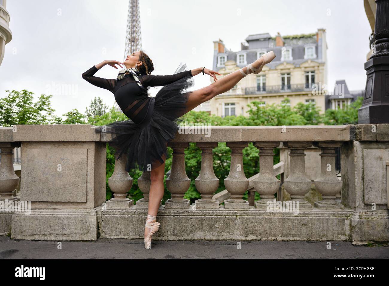 Ballet dancer posing on Paris terrace with Eiffel Tower view Stock Photo