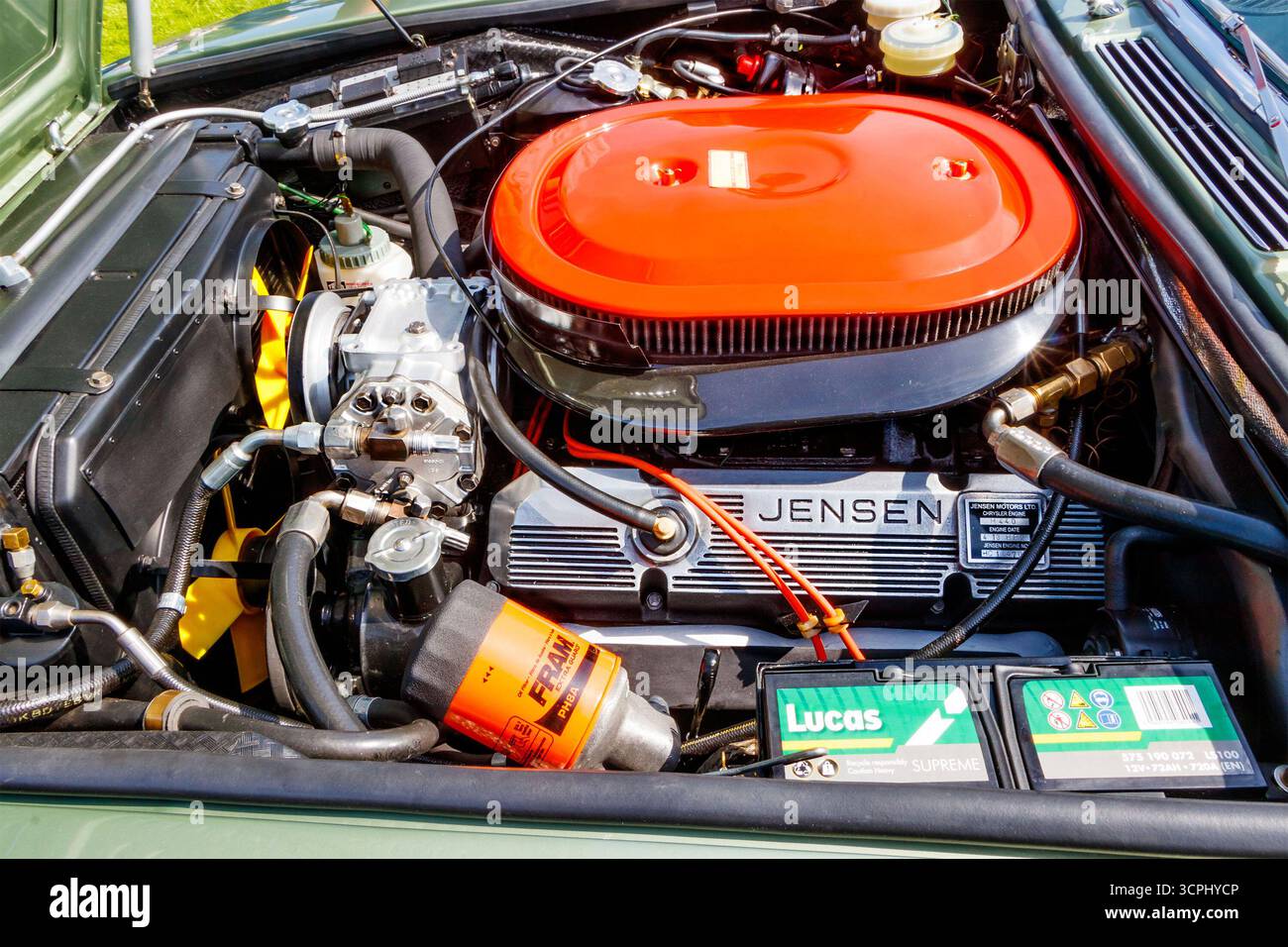 Close-up of a Jensen car engine featuring a prominent orange air filter and detailed components Stock Photo