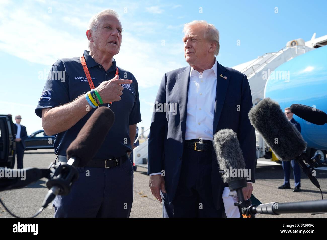 President Donald Trump listens as Nassau County Executive Bruce ...