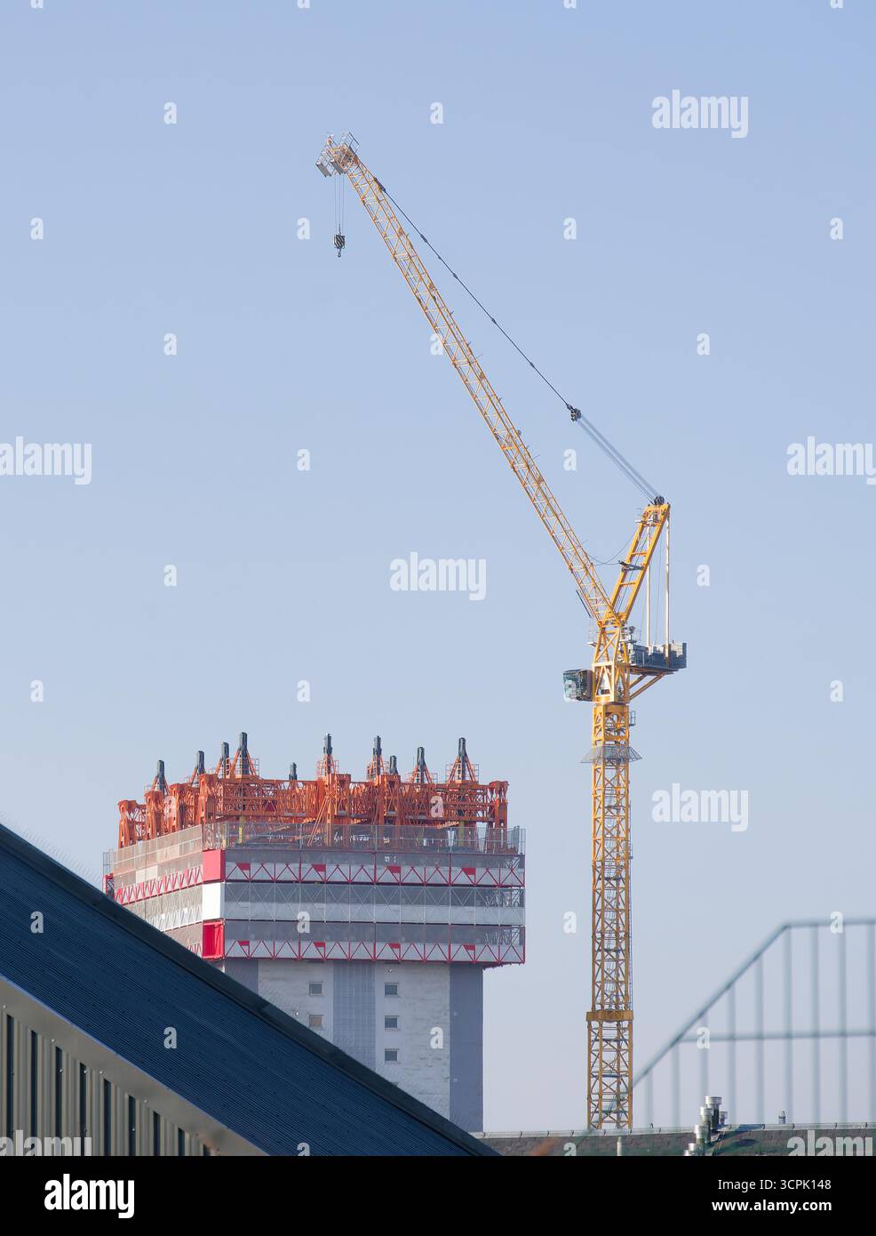 Tower crane high in sky at construction site Stock Photo - Alamy