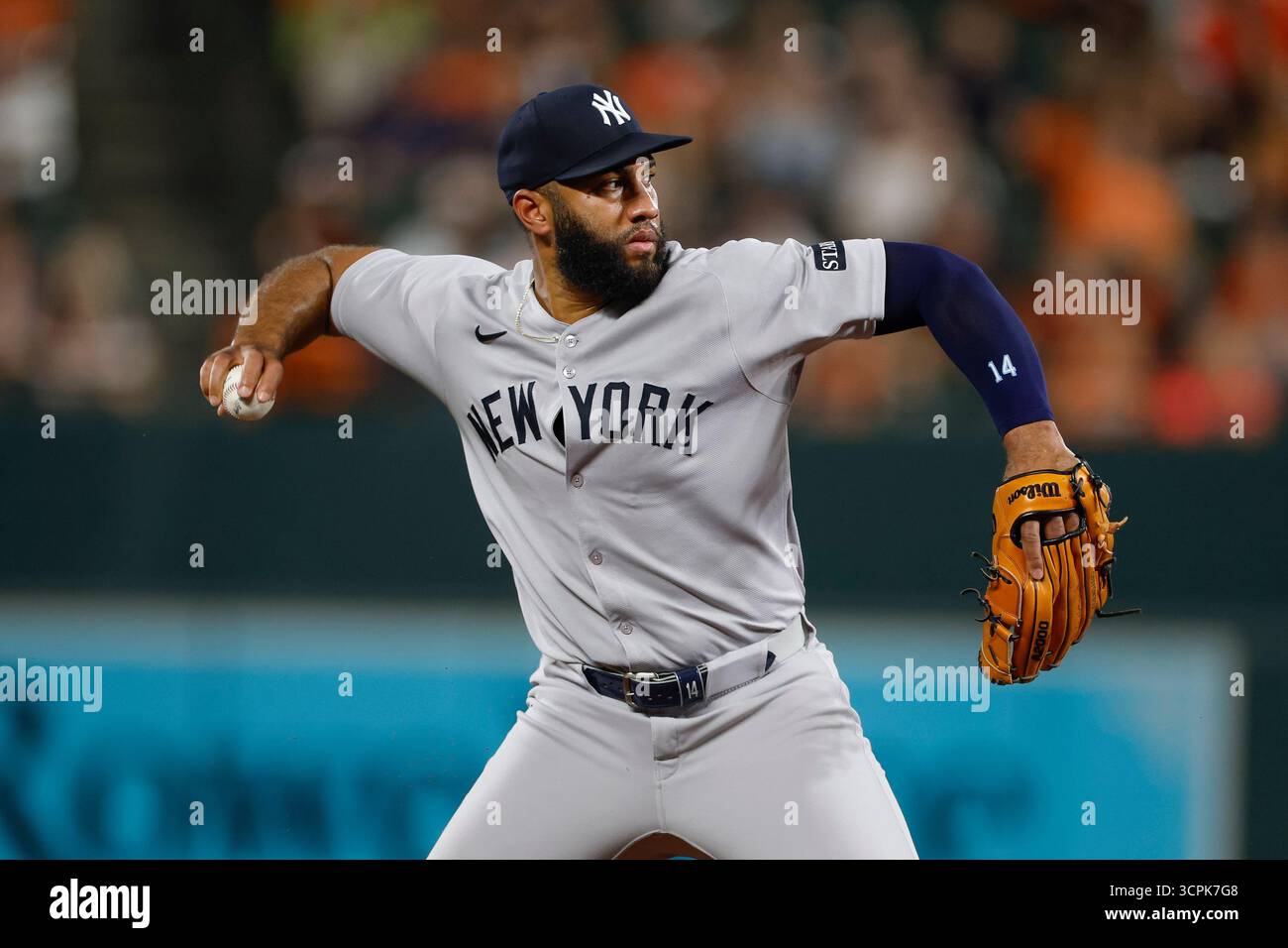 Amed Rosario #14 of the New York Yankees throws to first base for an