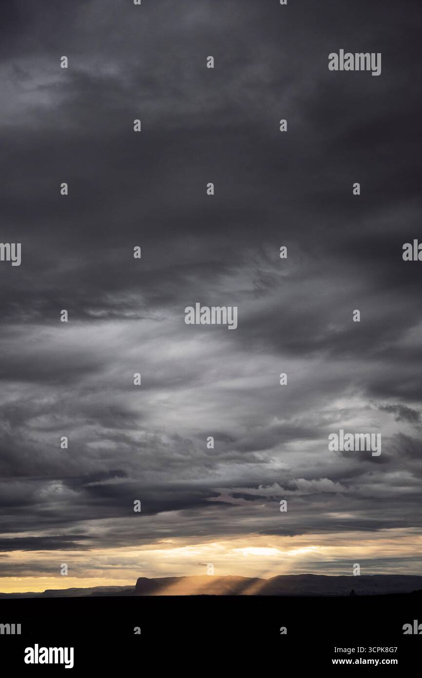 Dark clouds and sun beams Stock Photo