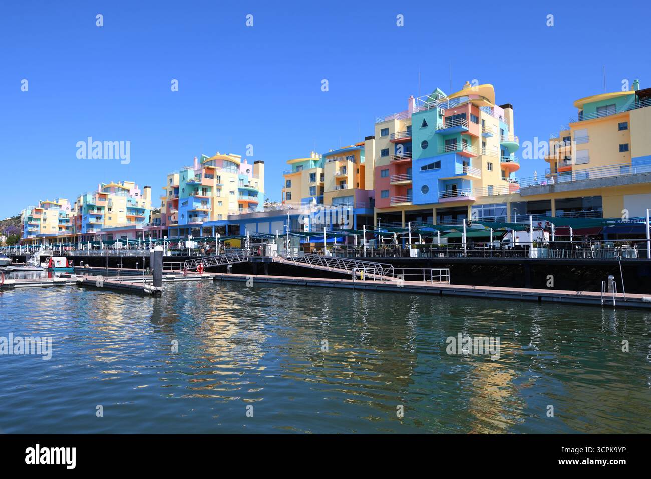 The candy coloured flats at the harbour promenade in the holiday resort of Albufeira, Portugal, Algarve. Stock Photo