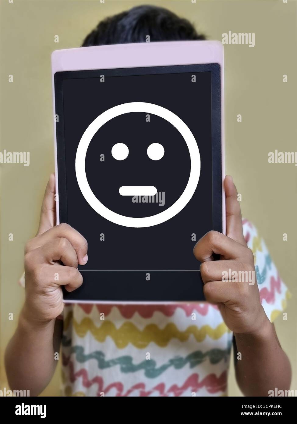 Child Holding 'No Clue' Face Board in front face - Smartphone Captured Stock Image