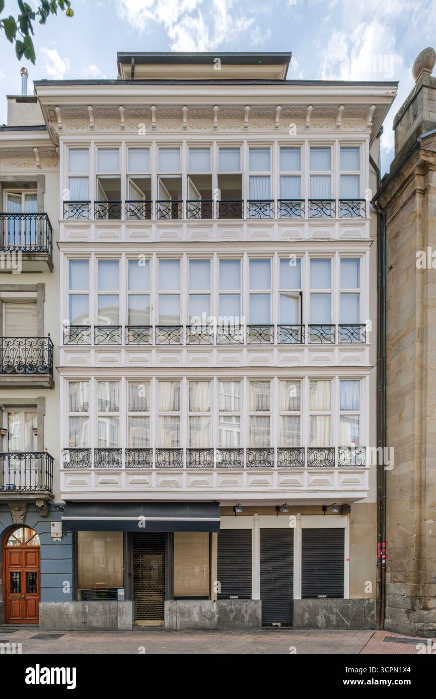 Traditional Basque Architecture Building With White Balconies in Vitoria Gasteiz Spain. Historic facade, ironwork, classic design, urban heritage Stock Photo