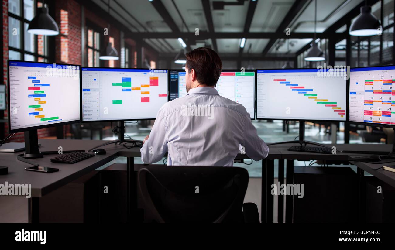 Senior Business Analyst Using Scrum Software To Manage Office Tasks Stock Photo