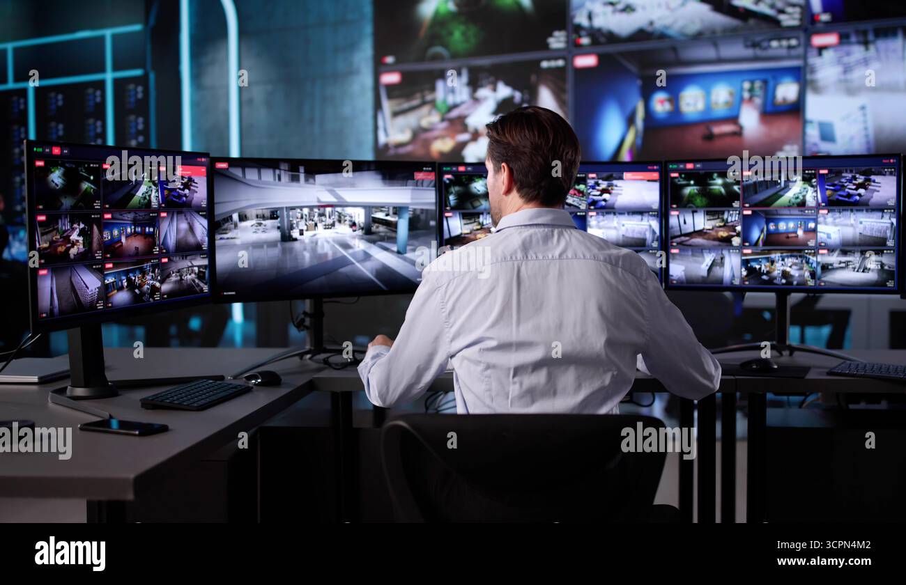 Elderly Security Guard Monitoring CCTV Feed In Control Room Stock Photo ...