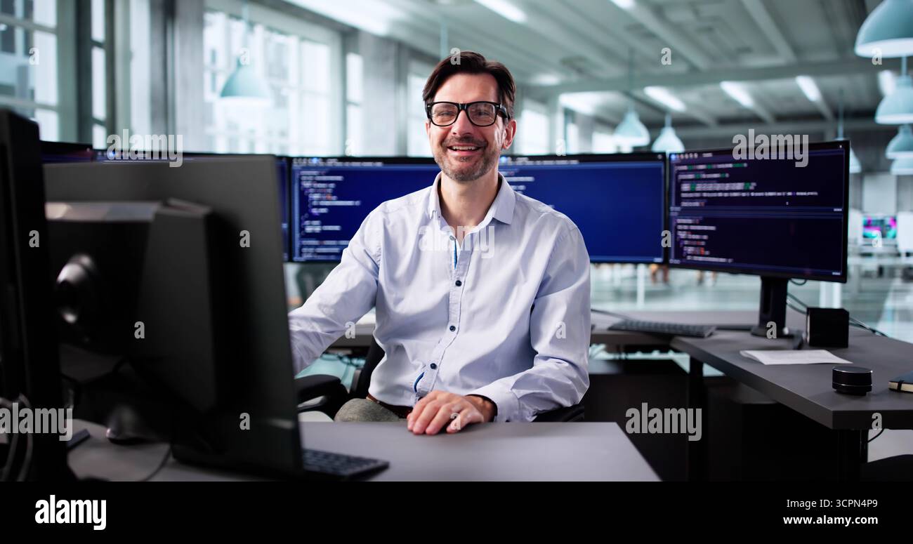 Elderly Programmer Smiling While Writing Code For Web Development Project. Stock Photo