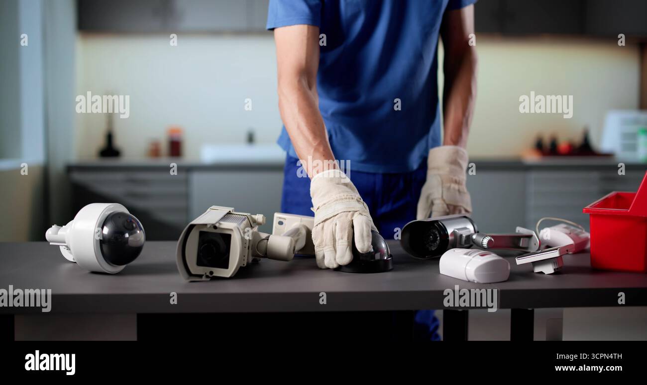Senior Technician Installing Surveillance Camera For Building Security System Stock Photo