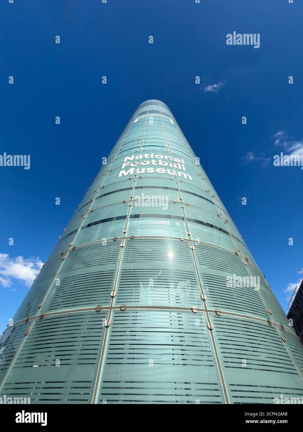 Looking up against a vivid blue sky at corner of National Football Museum ( previously Urbis building) in Manchester centre - Smartphone Captured Stock Image