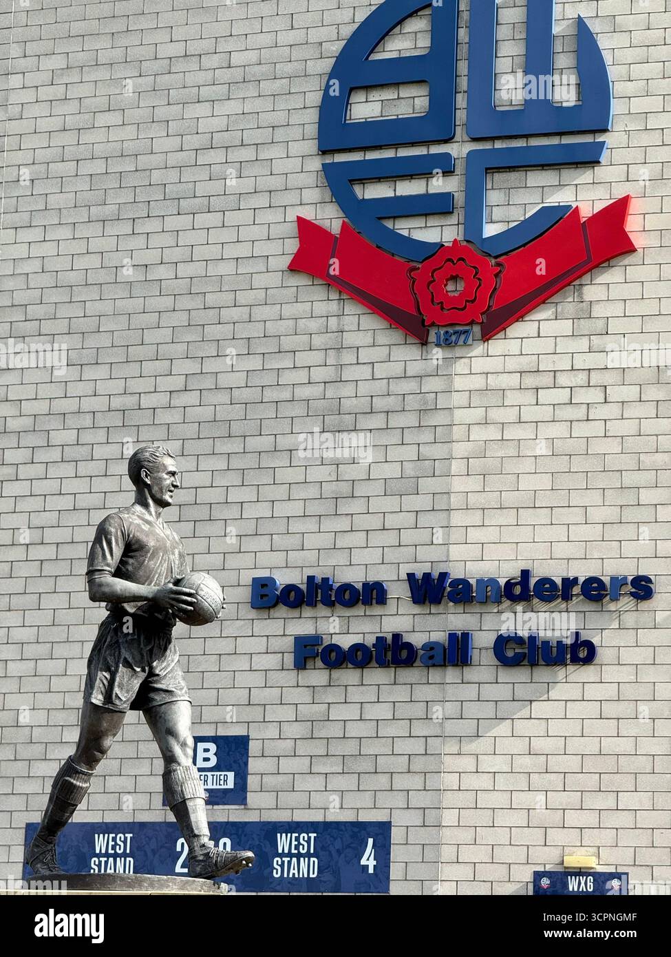 Bolton Wanderers Football club stadium. The Toughsheet Community stadium and statue of Nat Lofthouse OBE with BWFC logo - Smartphone Captured Stock Image