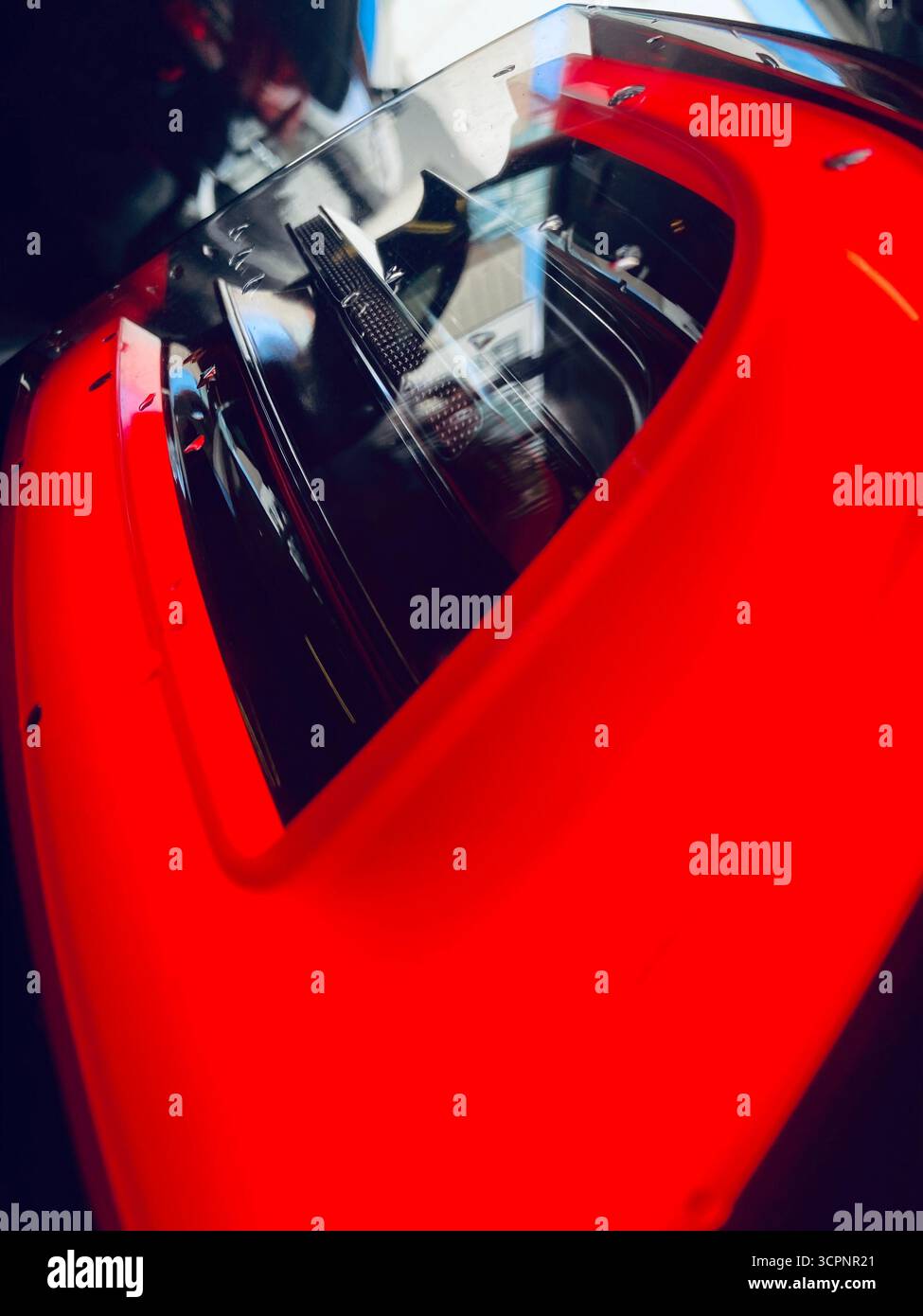 Rear Engine View of Red Sports Car with Transparent Cover - Smartphone Captured Stock Image