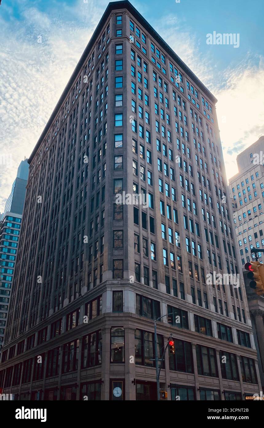 Triangular-Shaped Commercial Building in Urban Intersection with Classic Architecture - Smartphone Captured Stock Image
