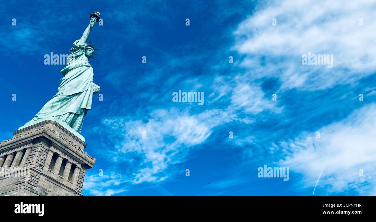 Statue of Liberty Torch Against Blue Sky with Wispy Clouds in New York City - Smartphone Captured Stock Image Statue of Liberty Torch Against Blue Sky with Wispy Clouds in New York City - Smartphone Captured Stock Image