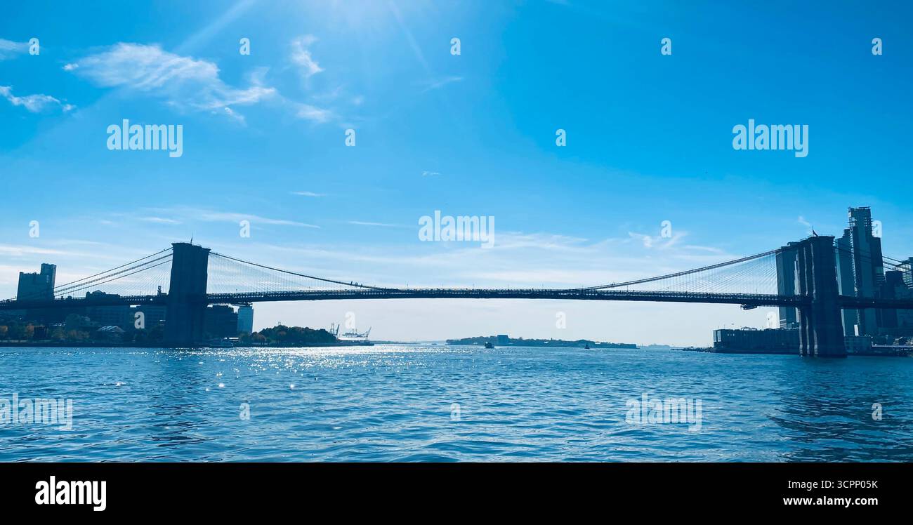 Brooklyn Bridge Spanning East River under Clear Blue Sky in New York City - Smartphone Captured Stock Image