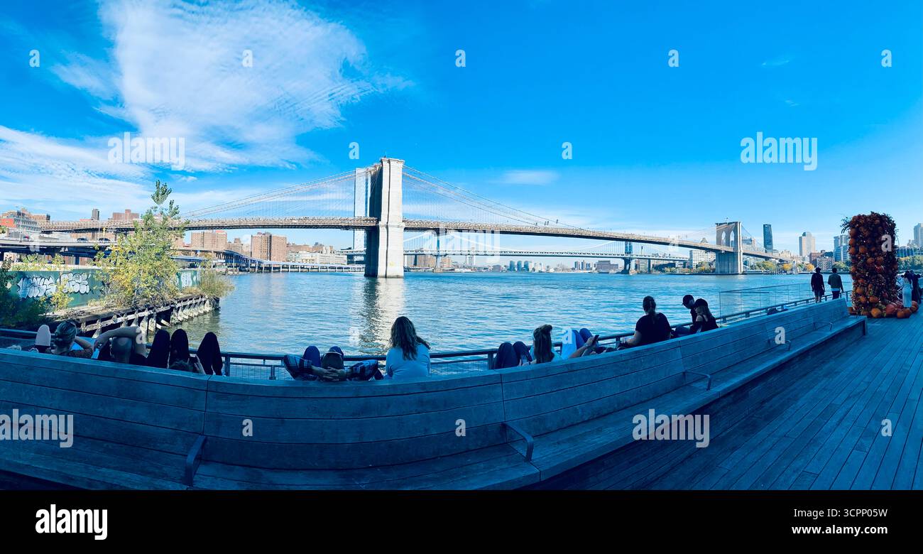 Brooklyn Bridge with Boardwalk, Autumn Pumpkins and Clear Blue Sky in New York City - Smartphone Captured Stock Image
