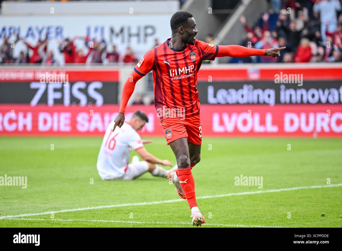 Heidenheim's Sirlord Conteh celebrates after scoring during the German ...