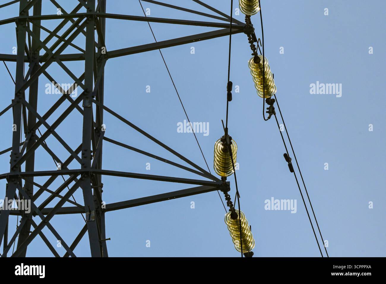 Close up view of the insulators on high voltage power lines on pylons ...