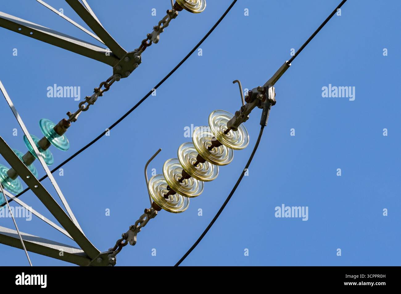 Close up view of the insulators on high voltage power lines on pylons ...