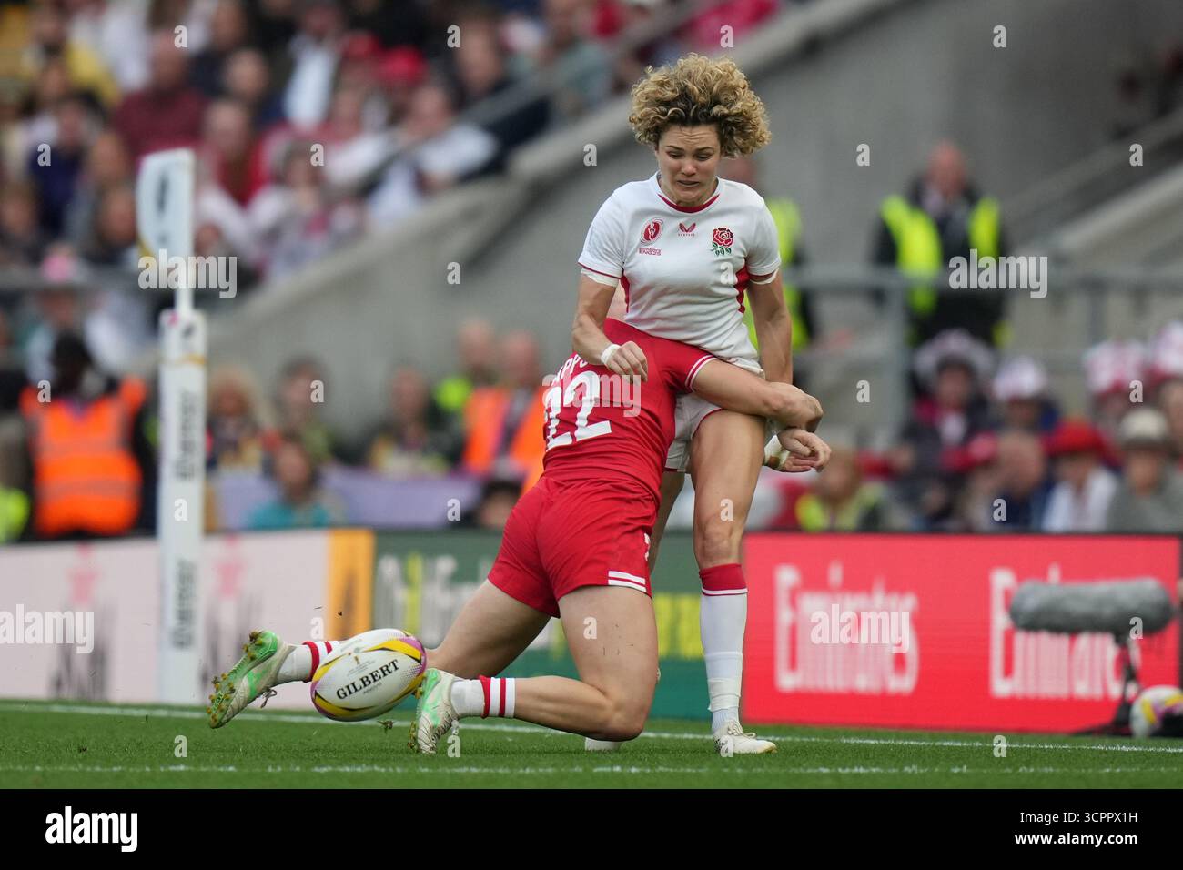England's Lark Atkin-Davies, top, is tackled by Canada's Olivia Apps ...
