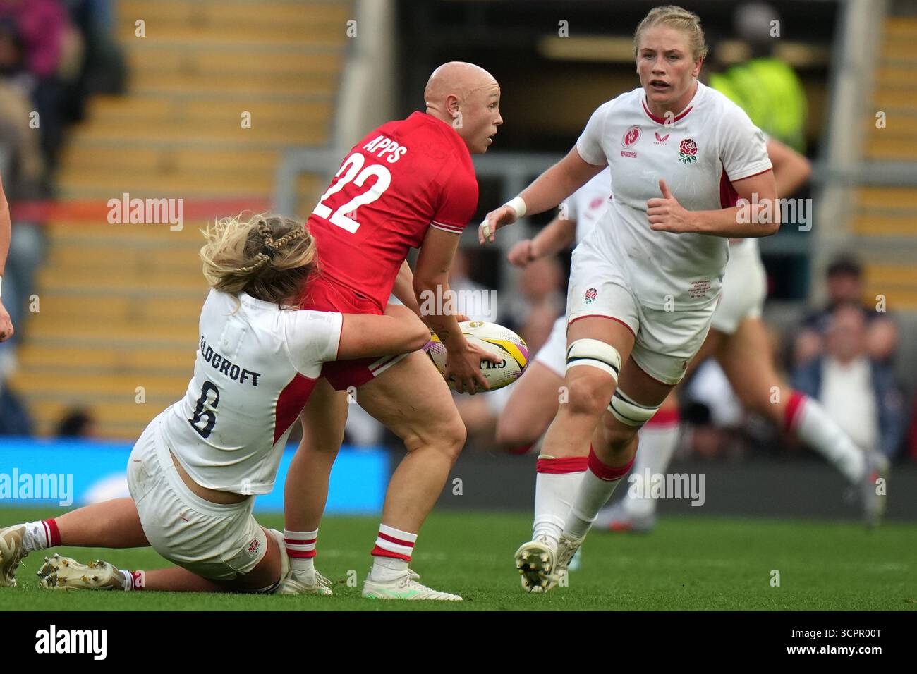 Canada's Olivia Apps, centre, is tackled by England's Zoe Aldcroft ...