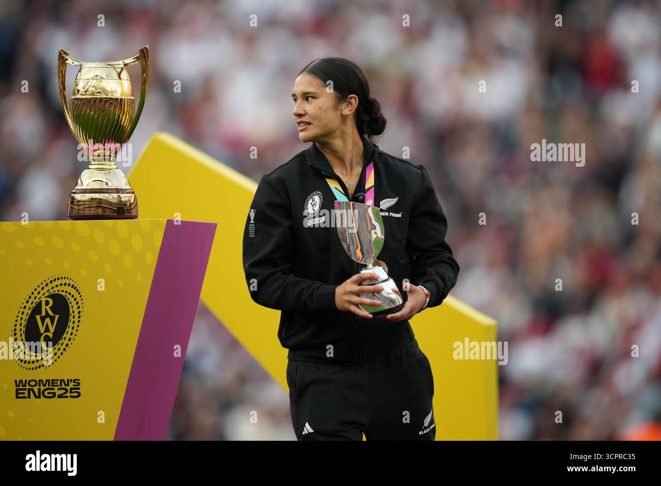 New Zealand's Braxton Sorensen-McGee walks past a World Cup trophy ...