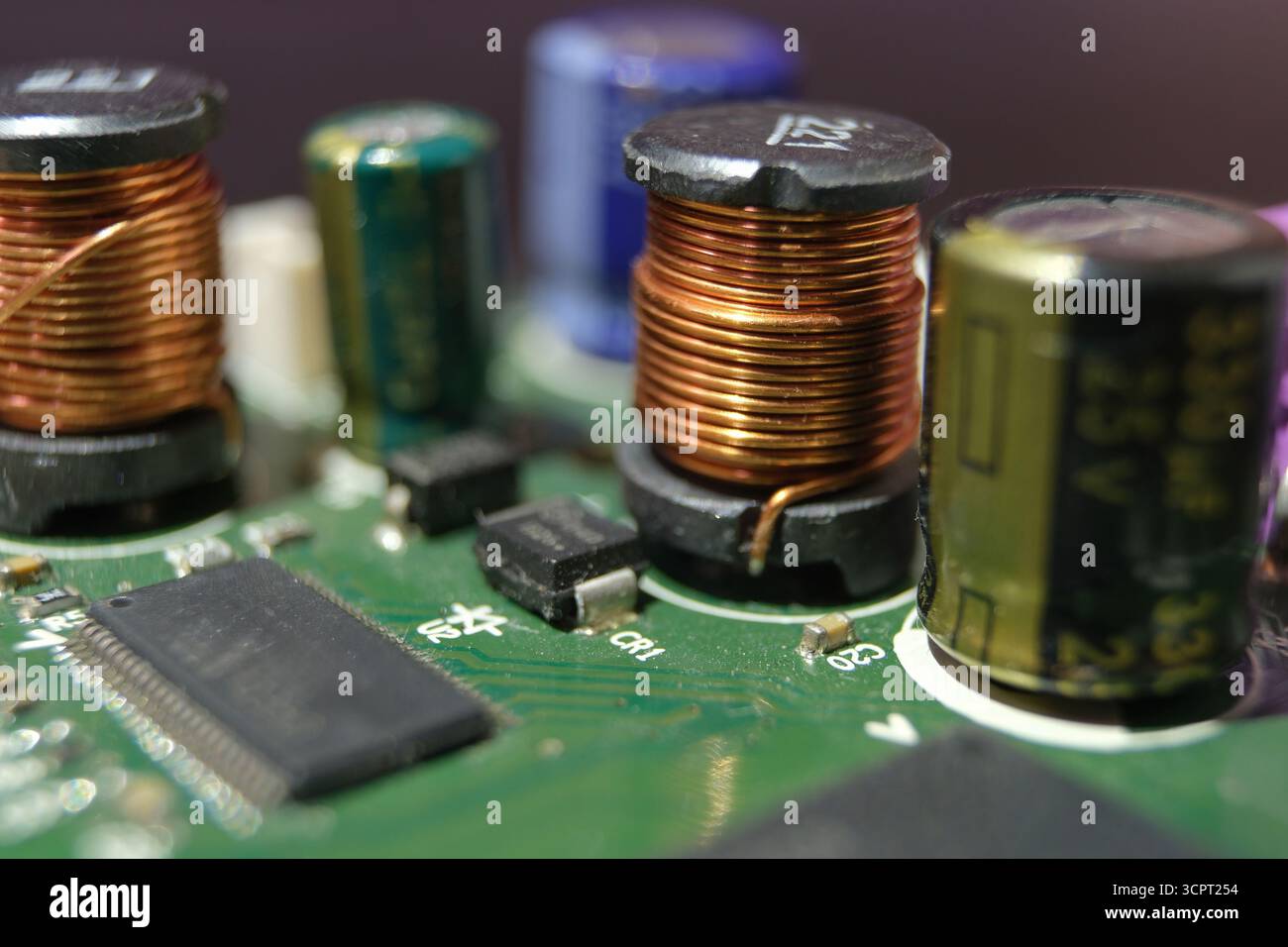 Use of copper mines in technology. Copper coil in high-tech electronic device. Stock Photo