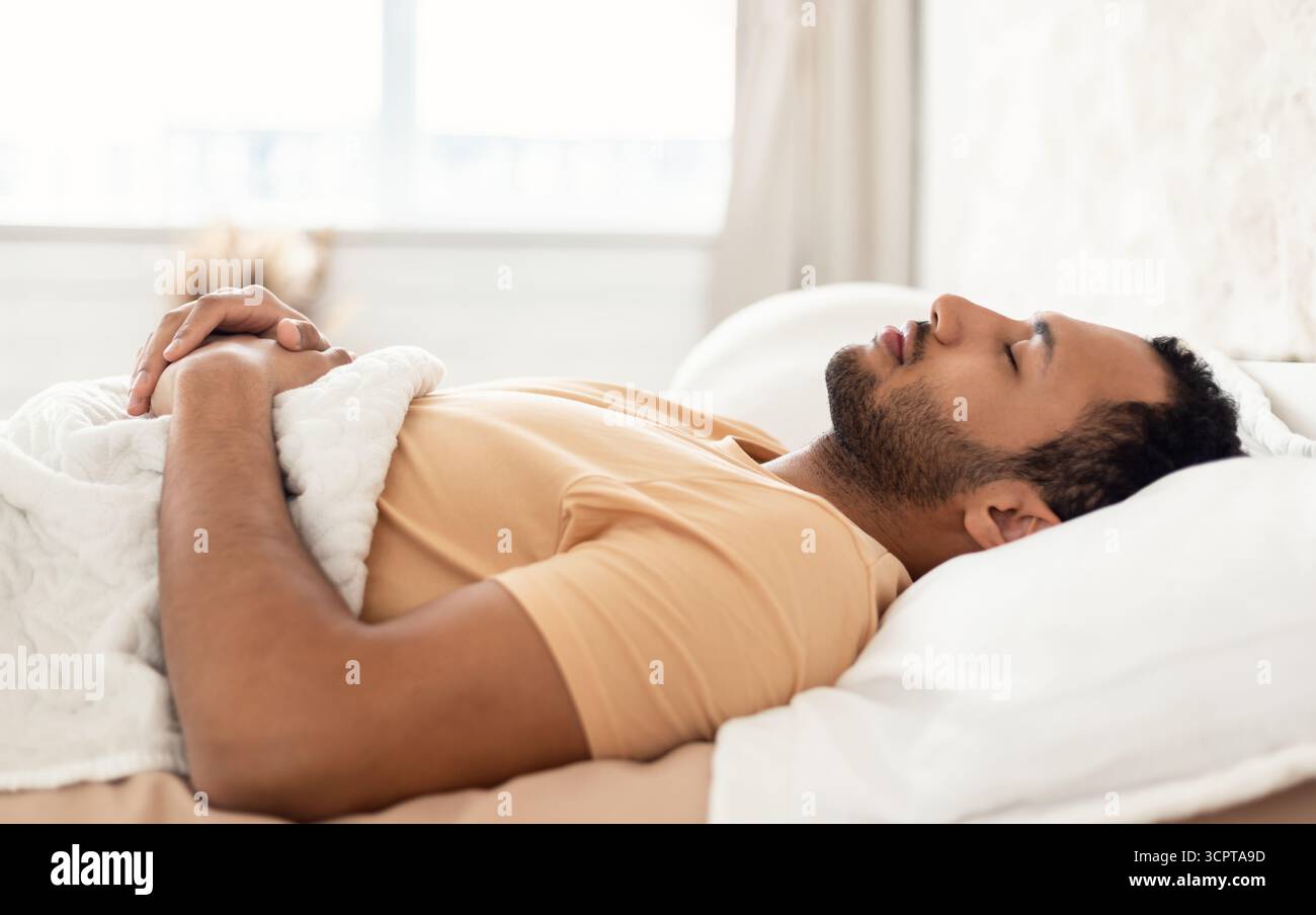 Arabic Young Man Sleeping Lying On Back Resting In Bedroom Stock Photo