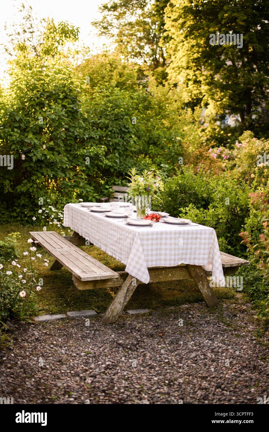 Tablecloth on dining table set for garden party Stock Photo