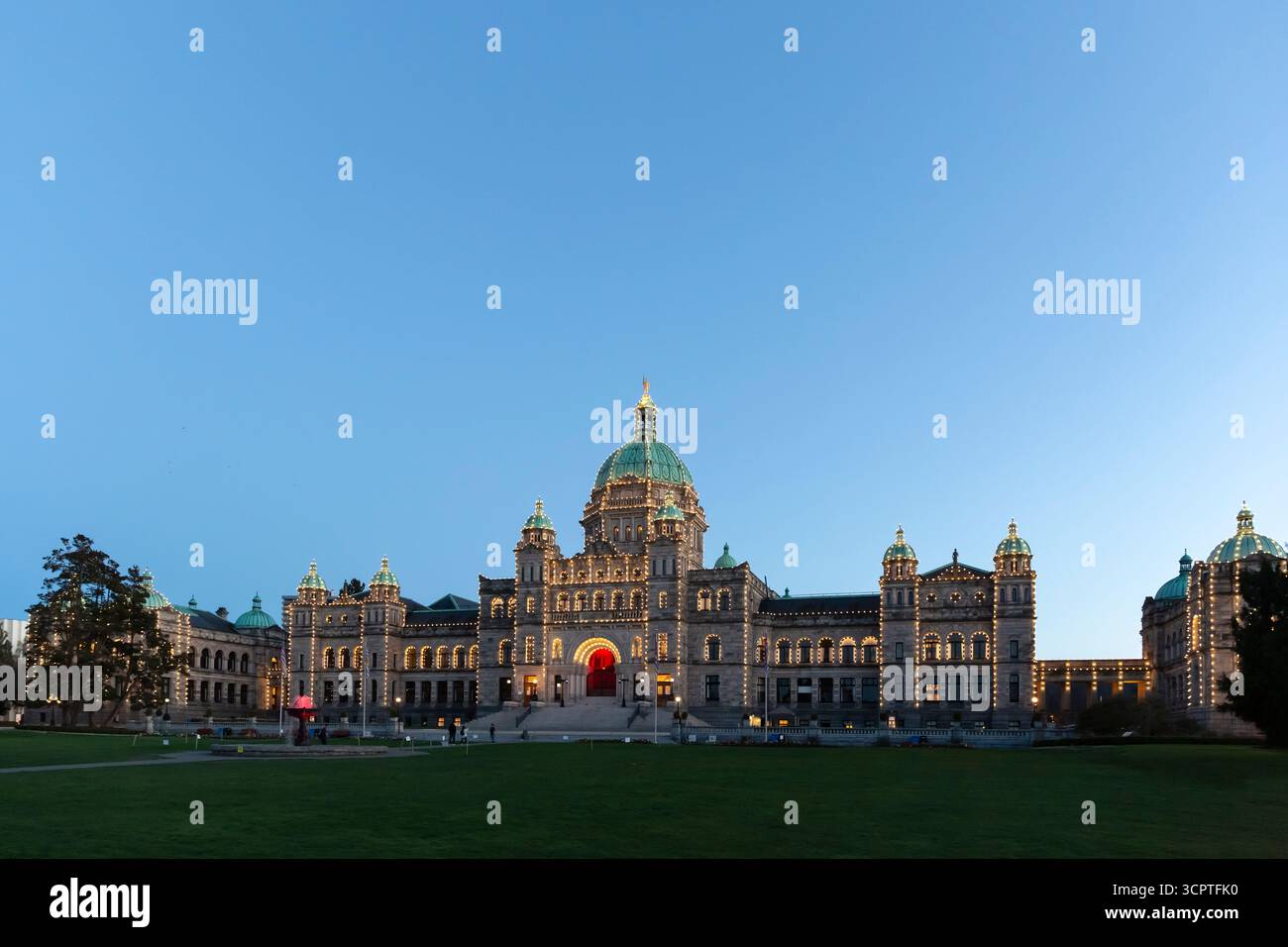 The British Columbia Parliament Buildings are illuminated as the sun sets in Victoria, British Columbia, Canada. Stock Photo