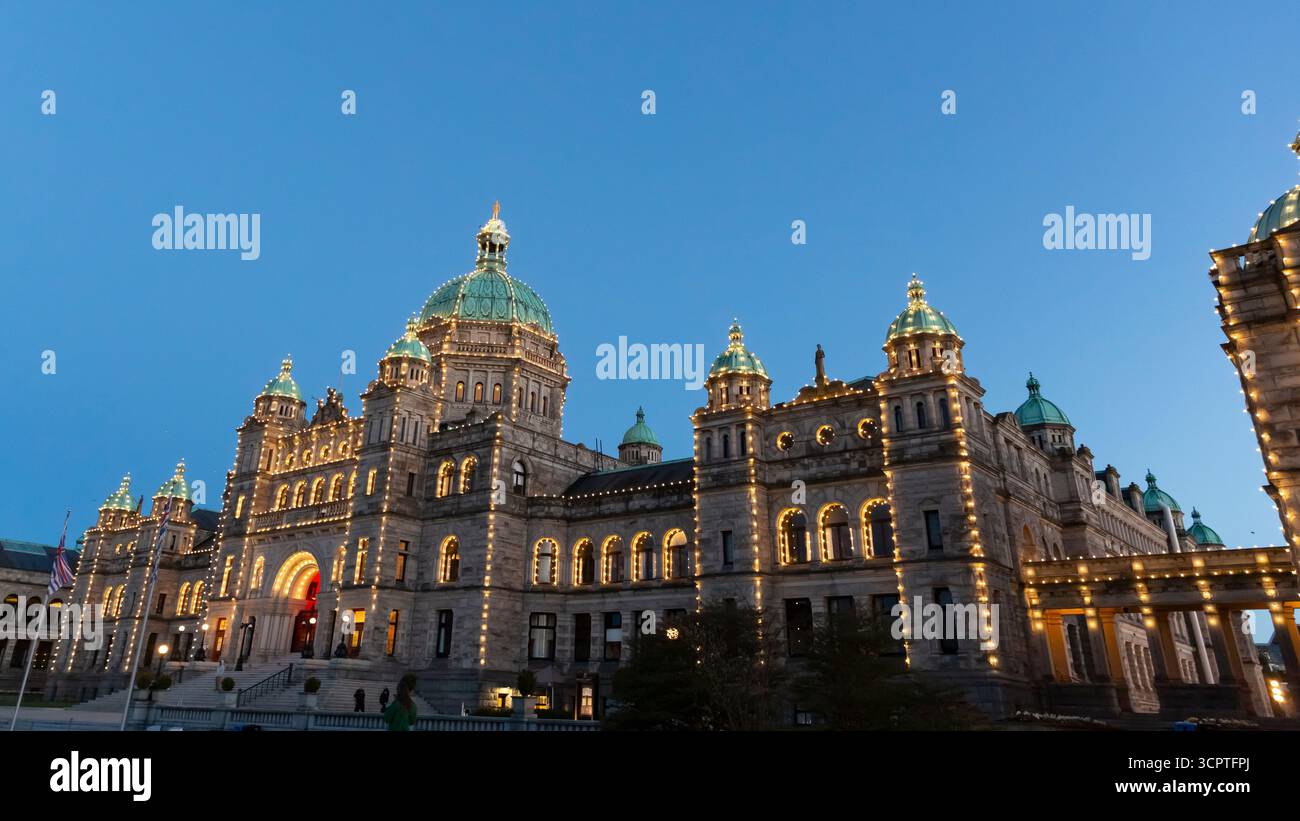The British Columbia Parliament Buildings are illuminated as the sun sets in Victoria, British Columbia, Canada. Stock Photo