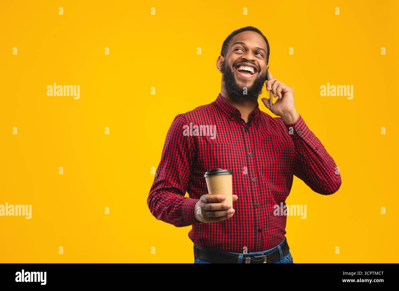 Smiling black guy talking on the phone at studio Stock Photo