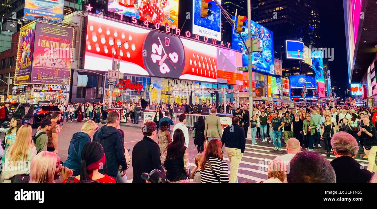 Times Square at Night with Crowd, Bright Billboards and Urban Energy in New York City - Smartphone Captured Stock Image