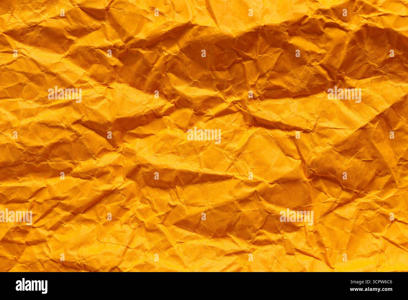 Crumpled Orange Paper Texture with Dimensional Folded Surface Stock Photo