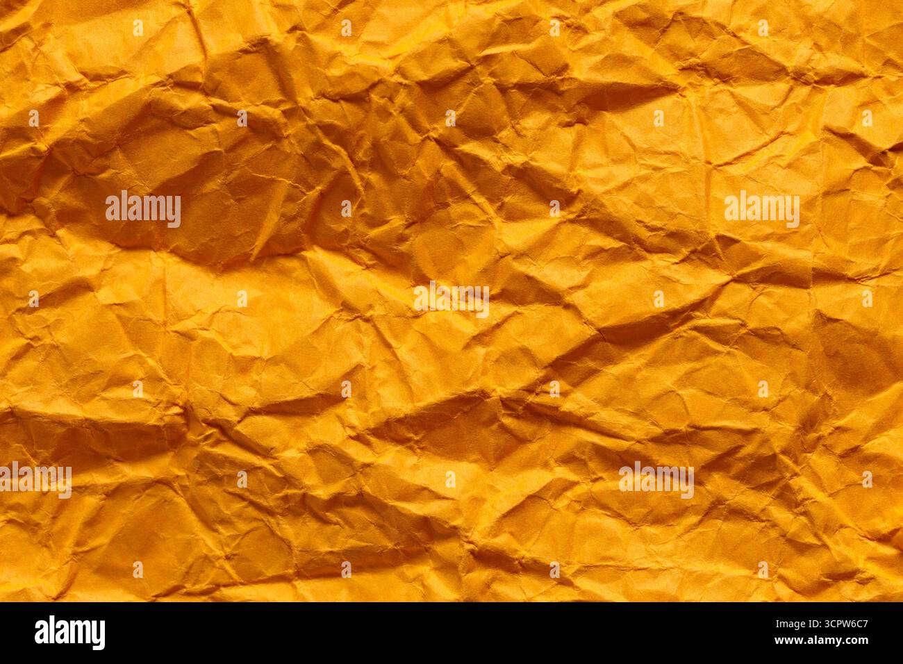 Crumpled Orange Paper Texture with Dimensional Folded Surface Stock Photo