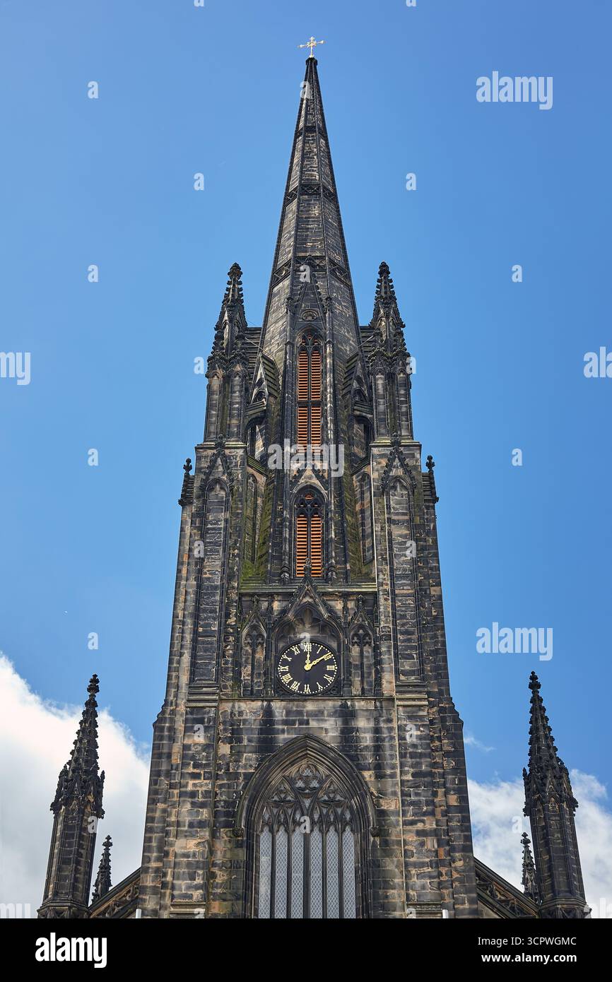 The gothic clock tower with tall pinnacled octagonal spire of Hub, a ...