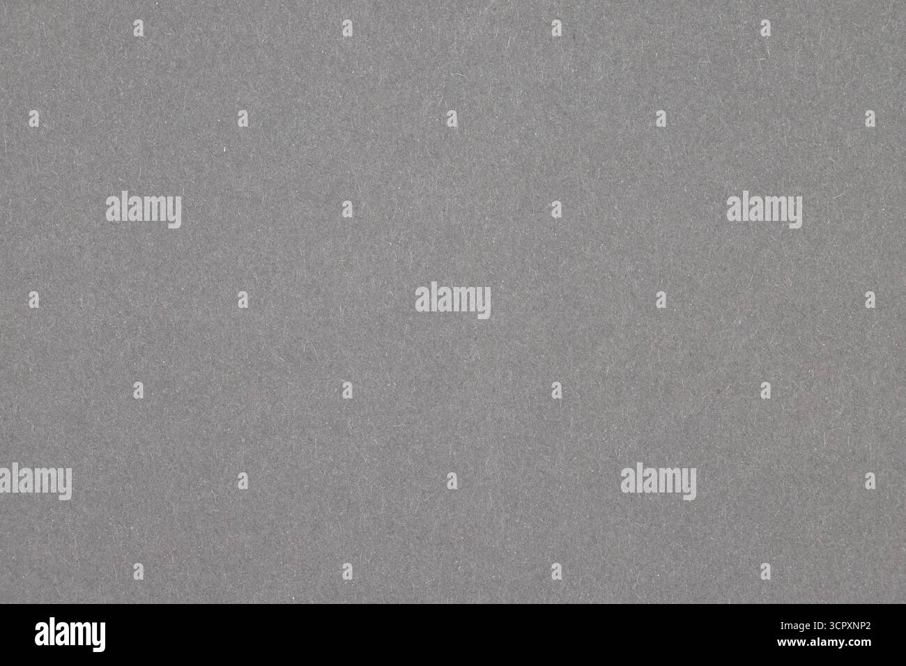 The image shows a uniformly textured, gray surface, likely paper or fabric, filling the entire frame. Stock Photo