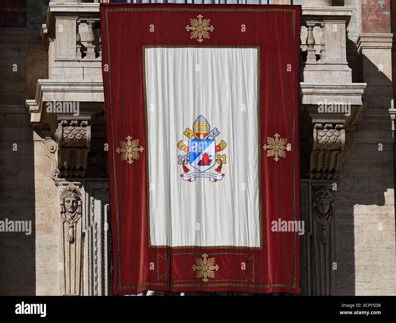 A tapestry with Pope Leo XIV's coat of arms is on the central balcony ...
