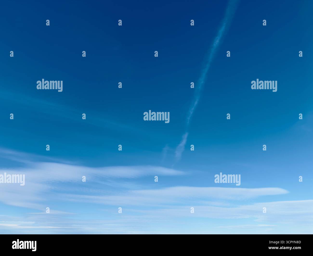 Blue sky with clouds and a contrail - Smartphone Captured Stock Image