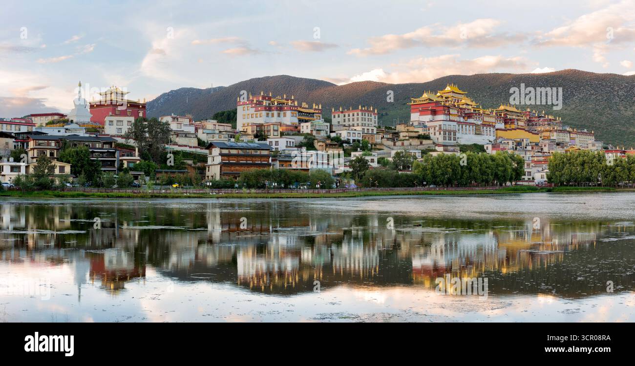 Songzanlin monastery with beautiful water reflection on lake in Shangri-La Yunnan China Stock Photo