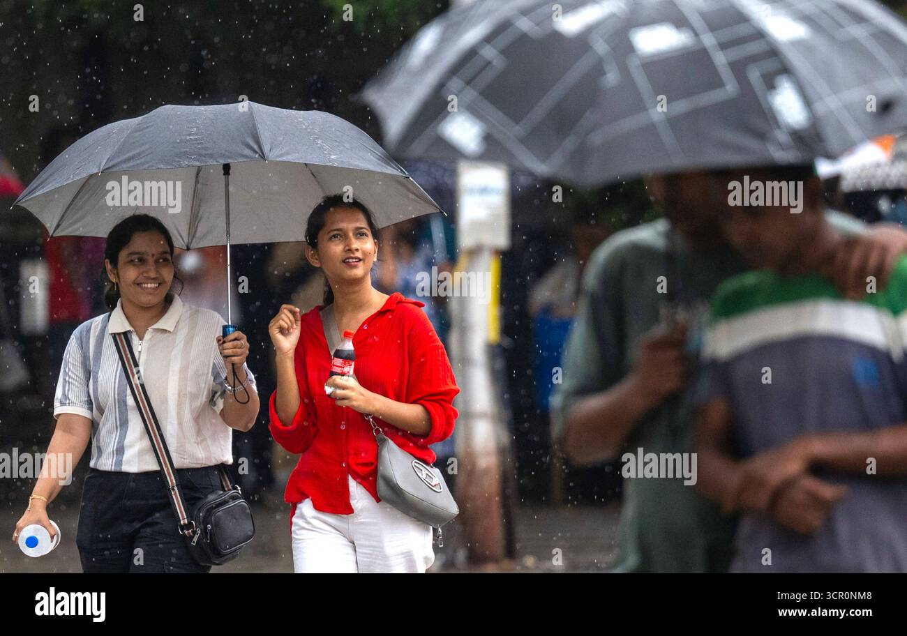 Imd Local MUMBAI, INDIA - SEPTEMBER 28: People going through the rain at Bandra ...