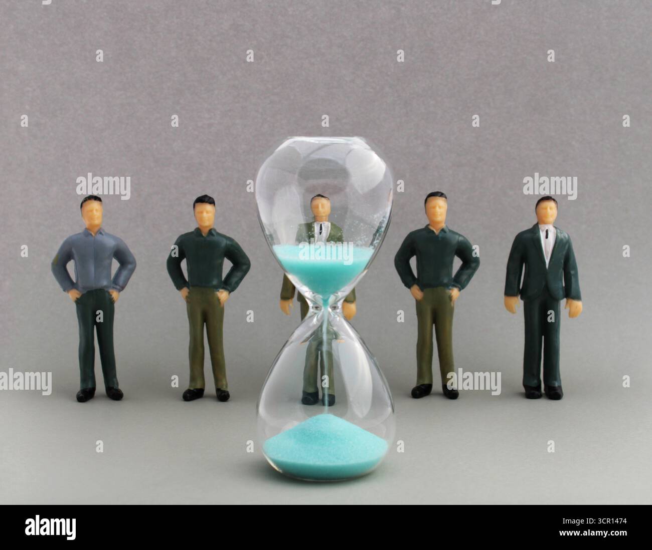 Work team in front of hourglass, time to complete tasks Stock Photo - Alamy
