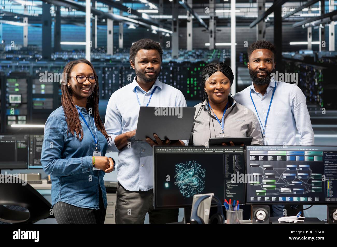 Portrait of smiling data center specialists using machine learning algorithms to analyze large datasets. Happy server farm coworkers using artificial intelligence to recognize facility data patterns Stock Photo