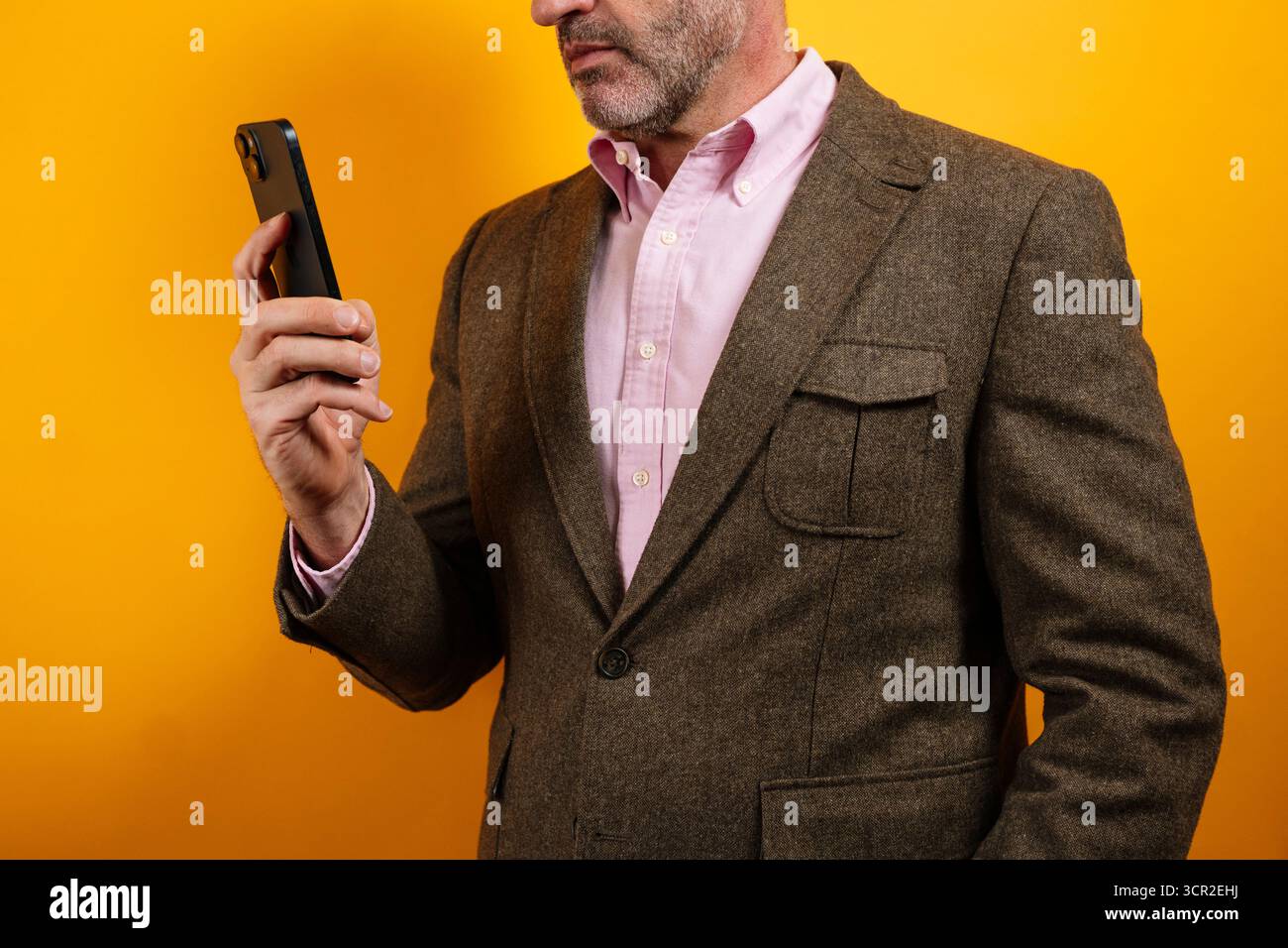 Man looking at smartphone with concentration in side profile Stock Photo