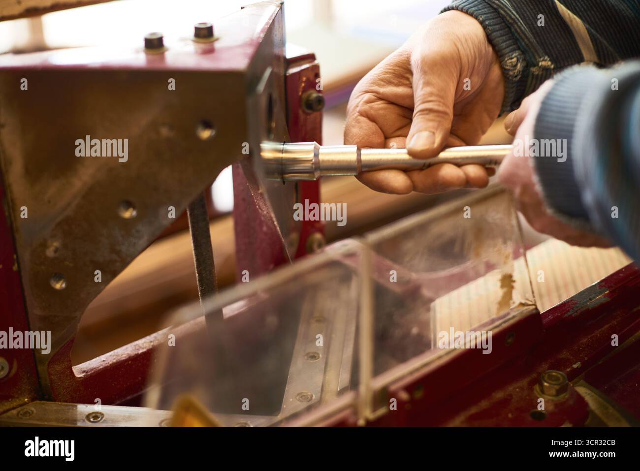 Man Operating Industrial Wood Cutting Machine Stock Photo