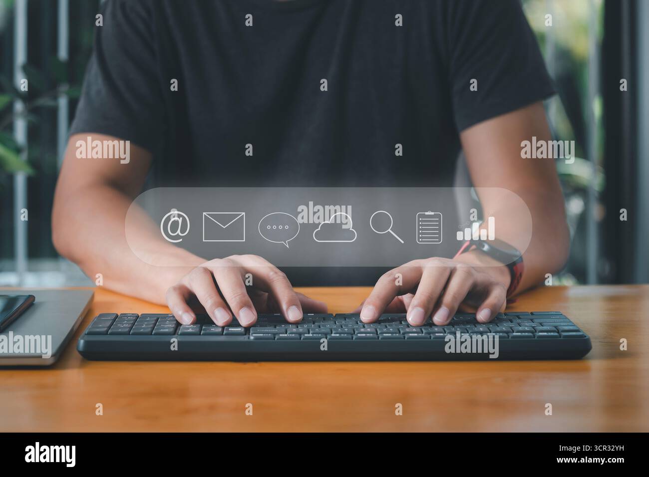 Businessman using computer keyboard for email, instant message, cloud system, search data, note document and business graph icons. Stock Photo