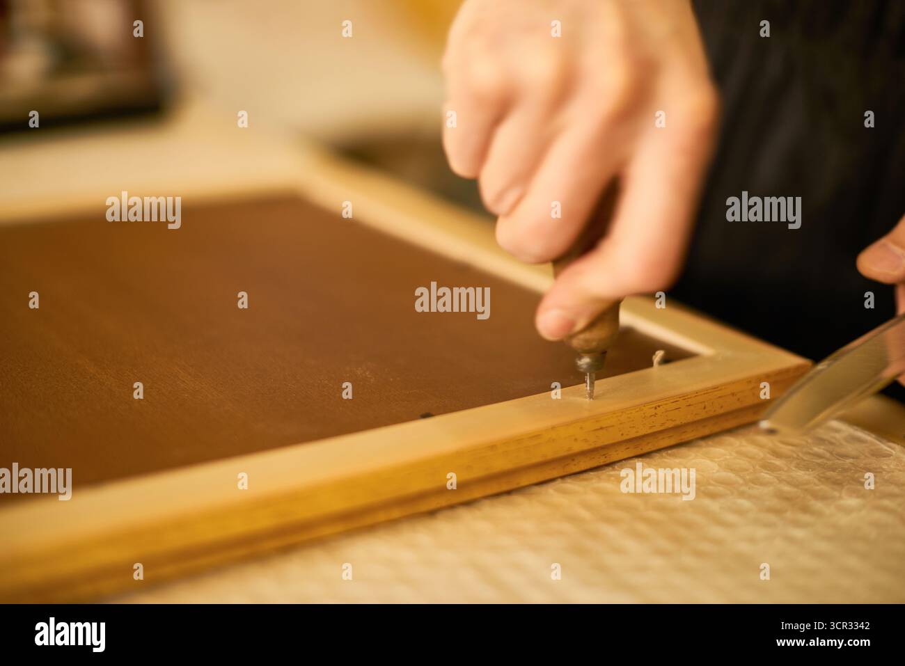 Man Assembling Wooden Frame Using Hand Tools Indoors Stock Photo