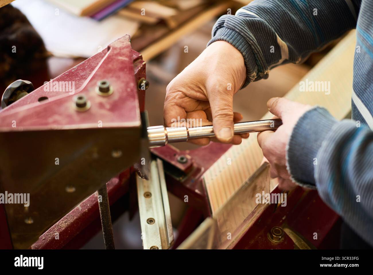 Man Adjusting Woodcutting Machine Stock Photo